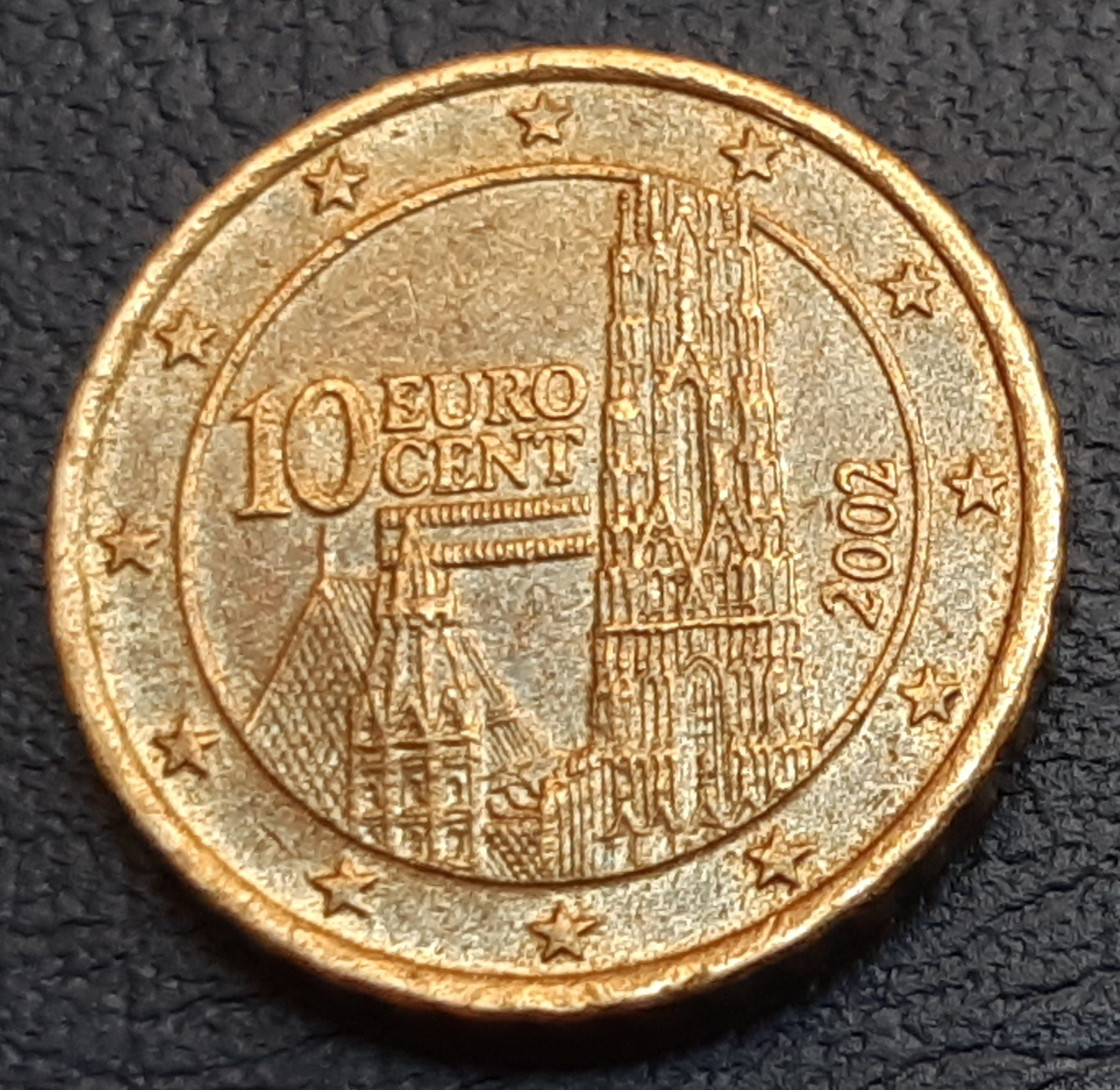 オーストリア 1ユーロ 2002年 10セント硬貨の印刷ミス、約60°の刻印