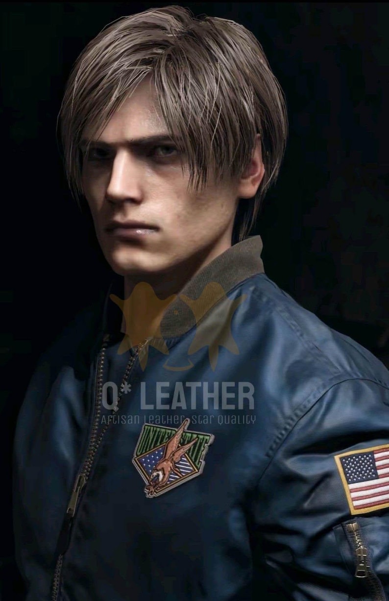 May include: A dark blue bomber jacket featuring a ribbed collar, a front zipper, and a patch on the chest with an eagle graphic and the text UNITED STATES. A United States flag patch is on the sleeve, with the text Q* LEATHER ARTISAN LEATHER STAR QUALITY.