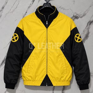 May include: A yellow and black zip-up jacket featuring a high collar, long sleeves with black cuffs, and a prominent X-Men logo emblem on each shoulder. The design includes a central yellow panel flanked by black side sections and a full-length zipper.