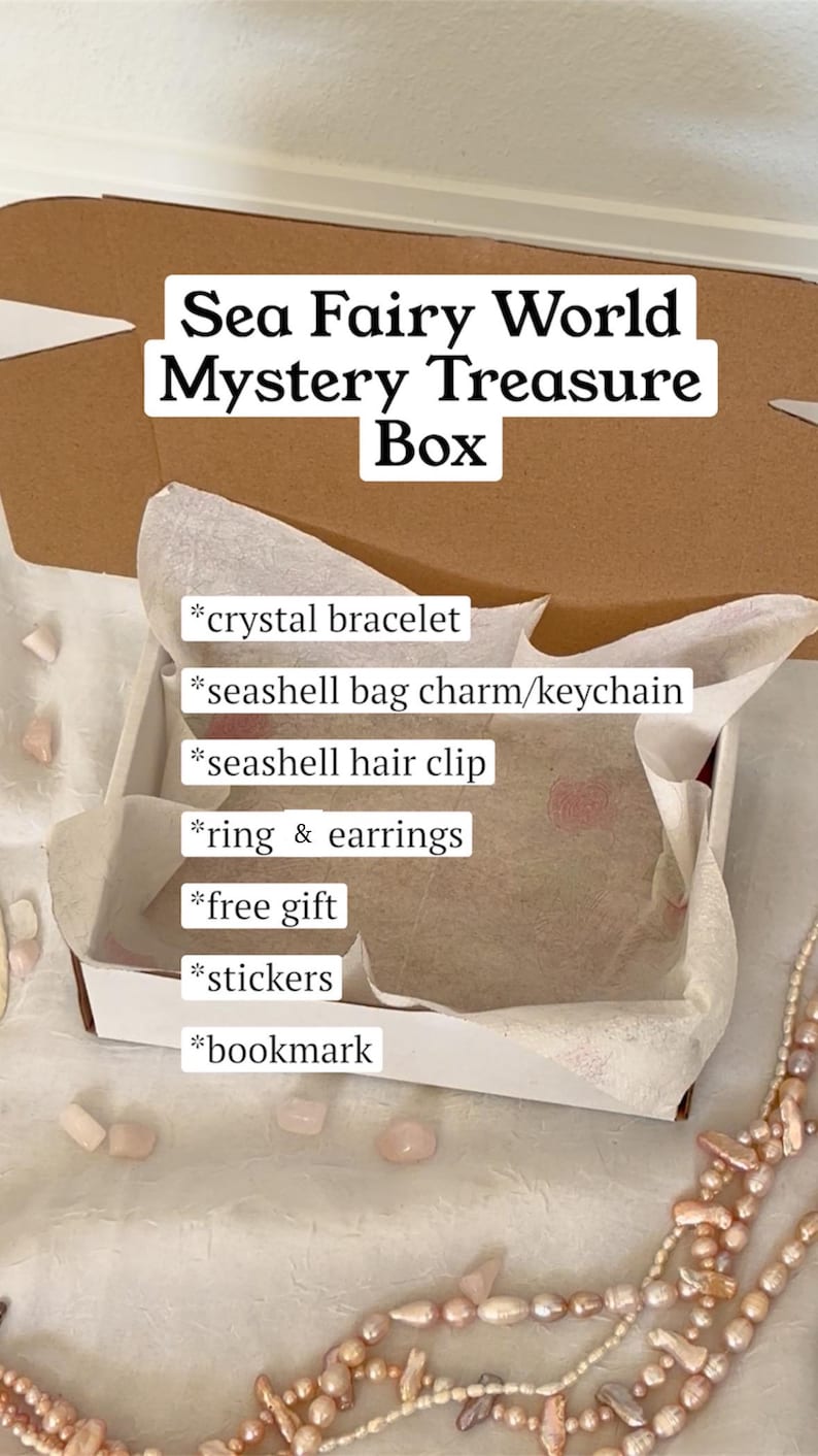 May include: A Sea Fairy World Mystery Treasure Box, open to reveal a crystal bracelet, seashell bag charm, hair clip, ring, earrings, stickers, and a bookmark. The box is lined with tissue paper and surrounded by decorative beads.