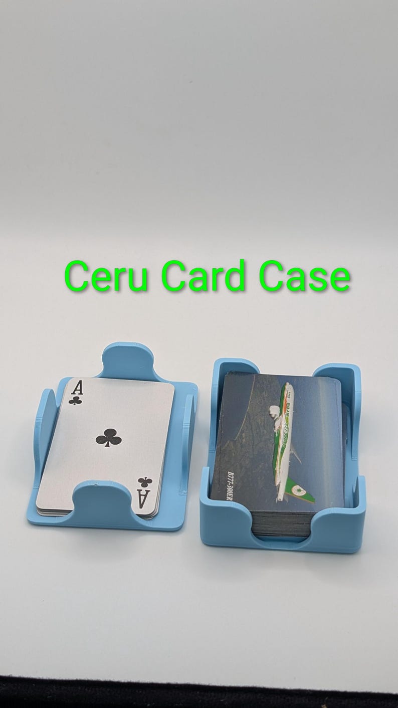 May include: Two light blue card cases, one holding an Ace of Clubs playing card, the other holding a deck of cards. The text "Ceru Card Case" is above the cases. The cards in the second case have a green and white design.