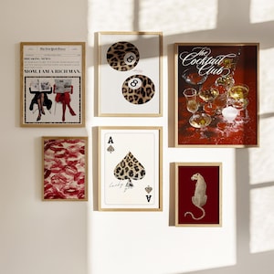 May include: A collection of eight framed prints with various designs. The prints feature a leopard print design, a newspaper clipping, a playing card, a leopard print cocktail glass, and a leopard print animal. The prints are all framed in a light wood frame.