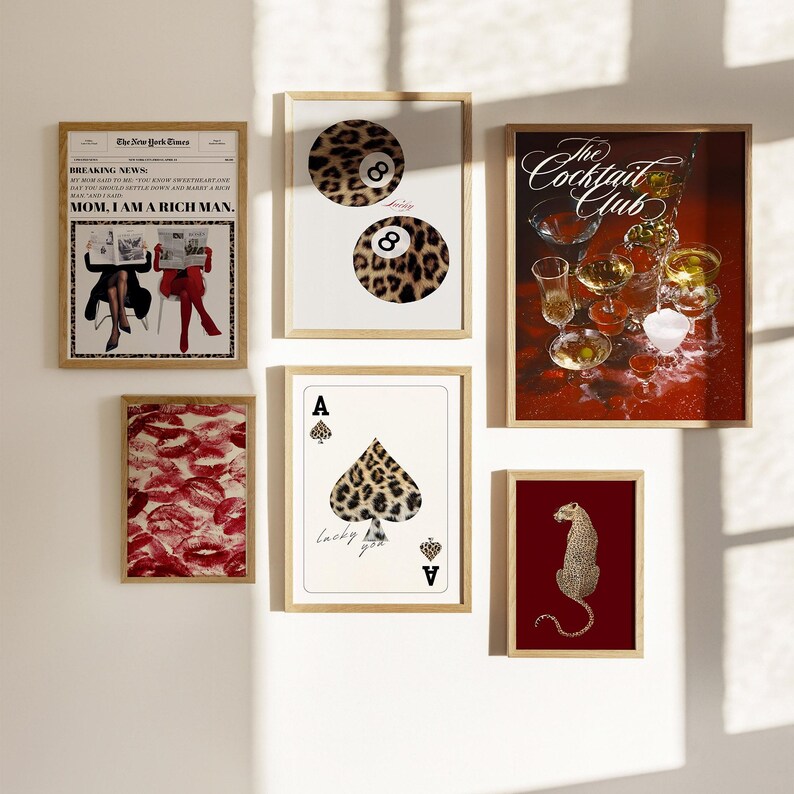 May include: A collection of eight framed prints with various designs. The prints feature a leopard print design, a newspaper clipping, a playing card, a leopard print cocktail glass, and a leopard print animal. The prints are all framed in a light wood frame.