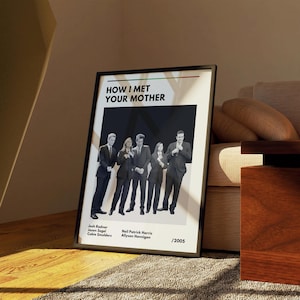 May include: A framed poster featuring the text "HOW I MET YOUR MOTHER" above a group photo of the cast. The poster includes the names Josh Radnor, Jason Segel, Cobie Smulders, Neil Patrick Harris, and Alyson Hannigan, with the year 2005.