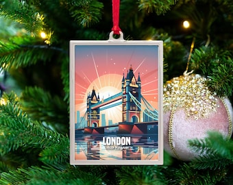 May include: A rectangular Christmas ornament featuring a colorful illustration of the Tower Bridge in London, with the text "LONDON United Kingdom". The ornament is hanging from a red ribbon on a Christmas tree.
