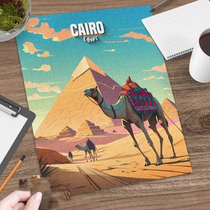 May include: A Cairo, Egypt puzzle featuring a camel in the desert with pyramids in the background. The puzzle has a blue sky with clouds and the word "Cairo" in white letters.