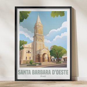 May include: Framed art print depicting the Santa Barbara D'Oeste church in Brazil. The illustration shows the beige church with a tall steeple, set against a blue sky with clouds and trees. The text "SANTA BARBARA D'OESTE" is displayed at the bottom of the print.