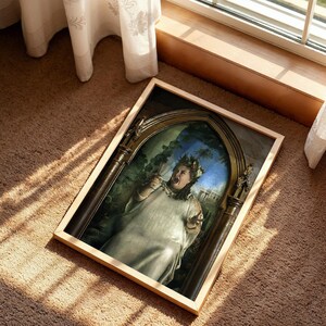 May include: A rectangular framed print featuring a person in a white toga and laurel wreath, holding a glass and shouting within a dark, arched stone structure. The artwork is set against a background of greenery and classical architectural elements.