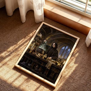 May include: A rectangular framed print featuring a dark, atmospheric illustration of a person with long black hair wearing a black coat, standing in a stone room filled with shelves, bottles, and a steaming cauldron while holding a glass vial.