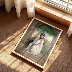 May include: A rectangular framed print featuring a person wearing a white draped garment and a dark leafy crown, seated on stone steps beneath an arched stone structure with green foliage, with a distant landscape visible in the background.