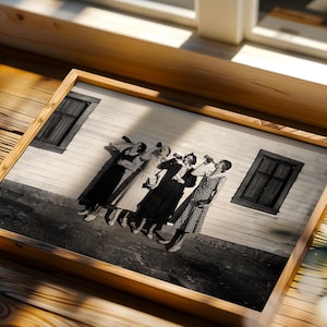 May include: A framed black and white photograph depicting four individuals standing in a row against a light-colored wall with two dark windows, each person holding a bottle to their mouth as if drinking, captured in a vintage style.