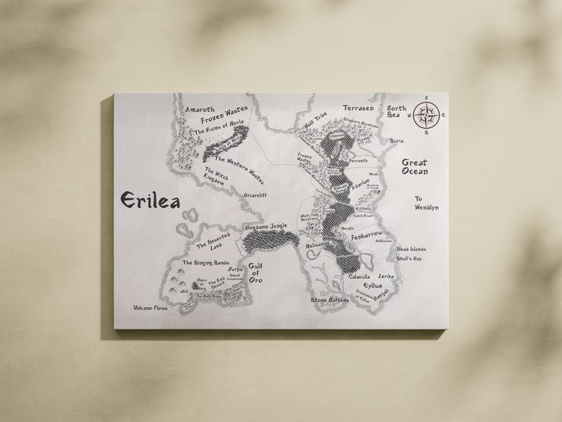May include: A black and white map of the fictional land of Erilea. The map shows various regions, including the Frozen Wastes, the Western Wastes, the Witch Kingdom, the Singing Sands, the Deserted Lakes, the Mogano Jungle, the Gulf of Oro, Calacala Jarva, Eyllue, and the Great Ocean. The map also includes a compass rose.