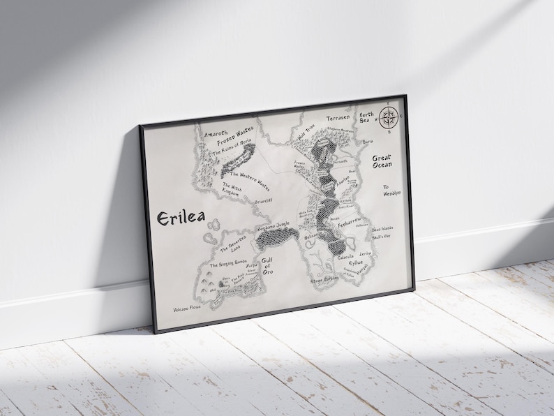 May include: A black and white map of the fictional land of Erilea. The map shows various geographical features, including mountains, rivers, forests, and a large ocean. The map is framed in a black frame.