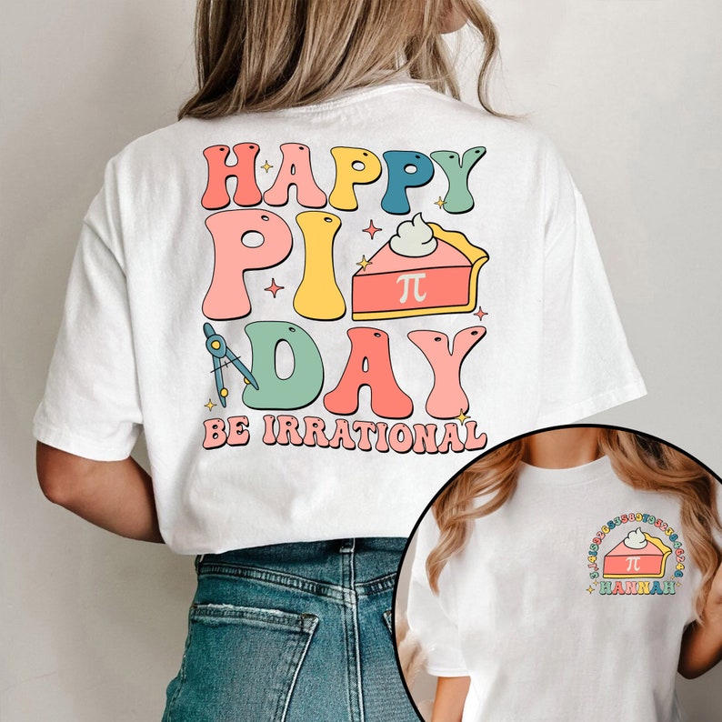 May include: White t-shirt with a colorful graphic that says "Happy Pi Day Be Irrational" with a pie slice featuring a pi symbol. The graphic also includes a compass and stars.