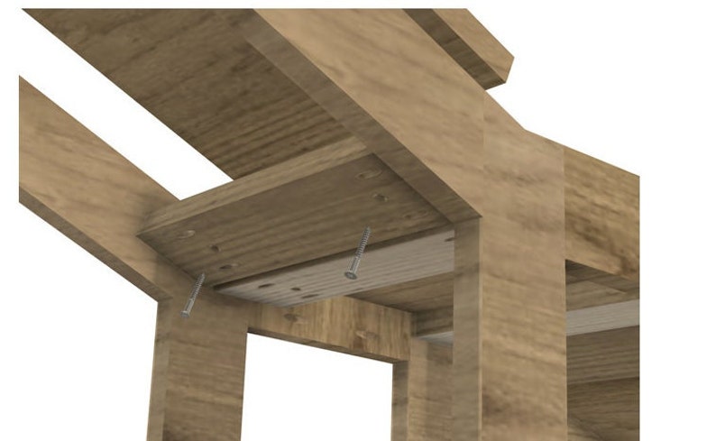 May include: Close-up of a wooden table frame with screws attaching the top to the legs. The wood is a light brown color.