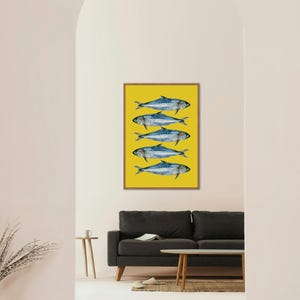May include: A framed print of five blue fish on a yellow background. The fish are arranged in a vertical line, with their tails pointing to the right.
