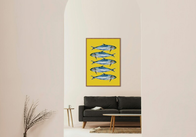 May include: A framed print of five blue fish on a yellow background. The fish are arranged in a vertical line, with their tails pointing to the right.