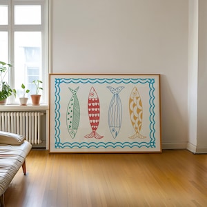 May include: A framed print of four colorful fish with different patterns, set against a white background with a blue wave border.
