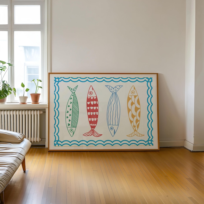 May include: A framed print of four colorful fish with different patterns, set against a white background with a blue wave border.