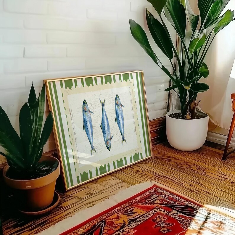 May include: A framed print with a green and white striped border. The print features three blue and silver fish with white outlines. The fish are arranged in a triangular pattern.