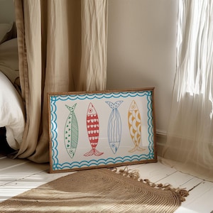 May include: A framed print of four colorful fish with a blue wave border. The fish are red, green, blue, and yellow with white outlines.