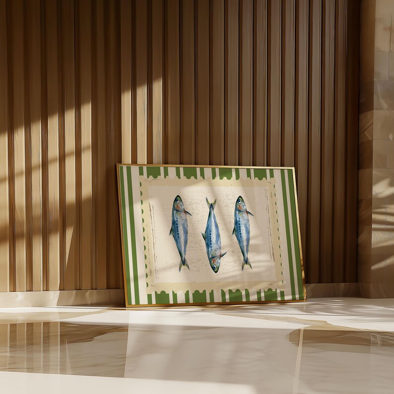 May include: A framed print with a green and white striped border. The print features three blue fish with white bellies, arranged in a row. The fish are on a white background with a vintage look.