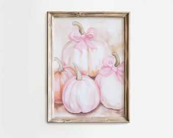 Puede incluir: Pintura de acuarela enmarcada de cuatro calabazas en tonos rosa y melocotón. Dos calabazas tienen lazos rosas. La obra de arte está en un marco de madera marrón claro rústico, ideal para la decoración de otoño.