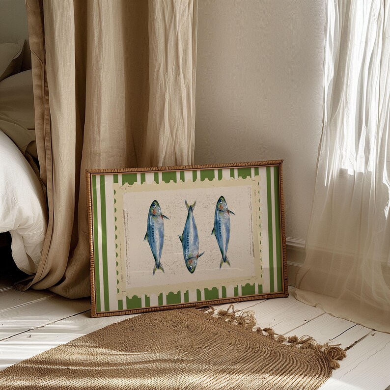 May include: A framed print with a green and white striped border. The print features three blue fish with white bellies, arranged in a row.