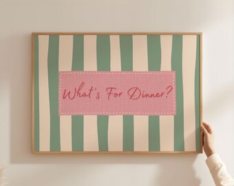 May include: A framed wall art print with a light wood frame. The artwork features vertical stripes in sage green and cream, with a pink rectangular patch in the center. The text "What's For Dinner?" is written in cursive.