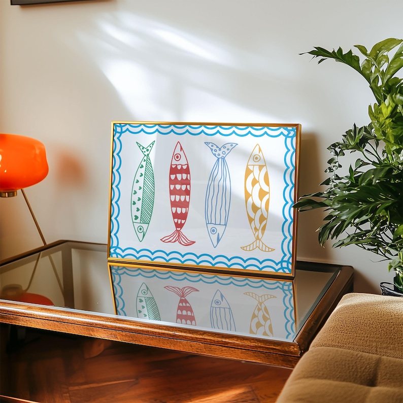 May include: A framed print of four colorful fish with wavy lines around the border. The fish are blue, green, red, and yellow with white outlines.