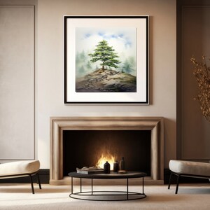 May include: A watercolor painting of a lone tree on a rocky outcrop, surrounded by fog. The painting is framed in a black frame and hangs on a wall in a living room setting.