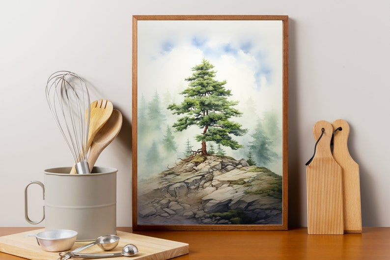 May include: A watercolor painting of a lone pine tree on a rocky cliff, surrounded by fog. The painting is framed in a light brown wood frame.