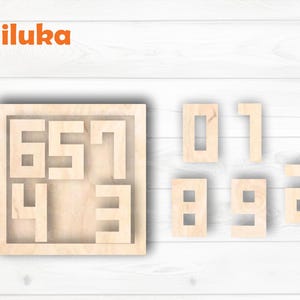 May include: Wooden number puzzle featuring the numbers 0, 1, 2, 3, 4, 5, 6, 7, 8, and 9. The numbers are light brown and cut from wood. The puzzle includes a square frame with the numbers 3, 4, 5, 6, and 7.