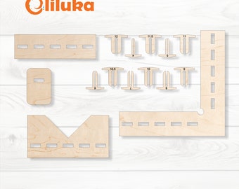 May include: A wooden craft kit with various pieces for building a model. The pieces are labeled with measurements in inches. The kit includes a base, walls, and a roof.