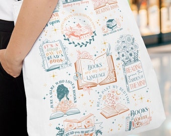 May include: White tote bag with a colorful design featuring books, flowers, and text about reading. The text includes phrases like "It's a good day to read a book", "Books are my love language", and "Reading grows the garden of the mind".