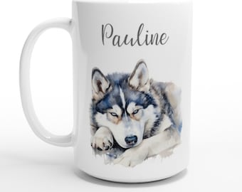 May include: White ceramic mug with a watercolor illustration of a husky dog. The dog is lying down with its head resting on its paws. The mug has the name "Pauline" printed on it in gray text.