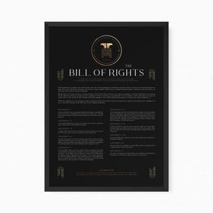 May include: A framed black poster featuring the text The Bill of Rights in white lettering. The design includes a gold circular emblem at the top, decorative gold corner accents, and the full text of the ten amendments in a clean, readable font.