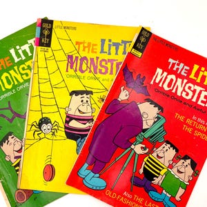 May include: Three vintage "The Little Monsters" comic books. The covers are green, yellow, and red, featuring cartoon monster characters and the title text. The comics have the Gold Key logo and various issue titles.