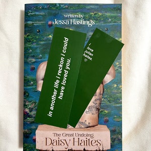 May include: A green bookmark with the text "in another life i reckon i could have loved you." and a second green bookmark with the text "I love Julian Haites."  The bookmarks are on top of a book titled "The Great Undoing" by Daisy Haites.