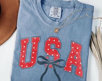 USA Bow Shirt, Patriotic Coquette Tee, Fourth of July Comfort Colors Shirt, American Flag Bow Graphic Tee for Women Cute Patriotic Gift