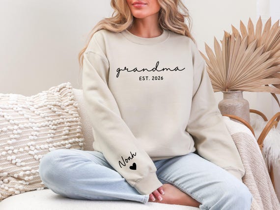 Personalized sweatshirt for Grandma with the grandchildren's names on the sleeve, perfect for Mother's Day gifts.