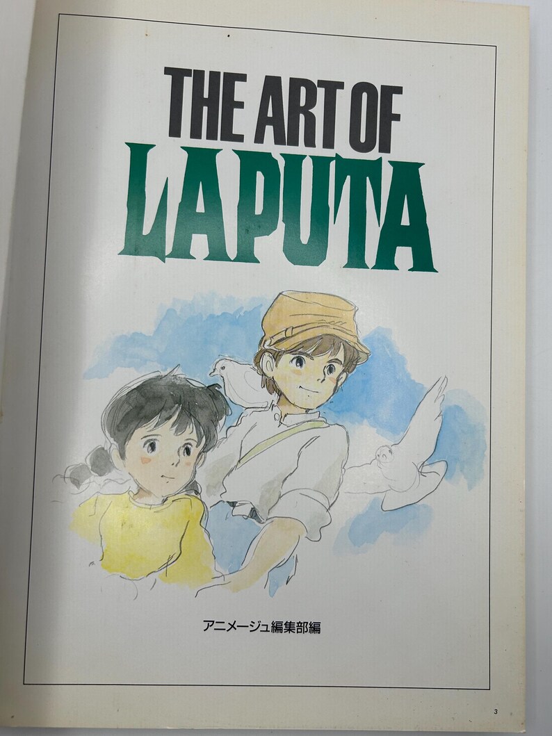 May include: A book cover featuring the title "THE ART OF LAPUTA" in black and green lettering. Below the title is an illustration of two children with doves. The book is a collection of art from the animated film.