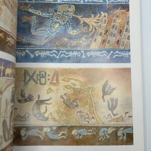 May include: Two-page spread from "The Art of Nausica&auml;" book. The top illustration depicts a blue figure with a flame, and a building. The bottom illustration shows figures, birds, and a tree. The page number is 23.