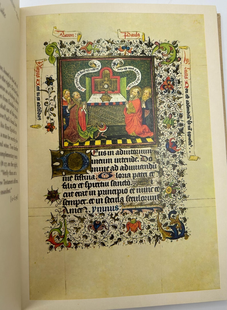 May include: A page from an illuminated manuscript featuring a central illustration of figures in red and gold robes, with text in Latin. The page is decorated with floral and foliate borders in green, red, and blue, set against a cream-colored background.