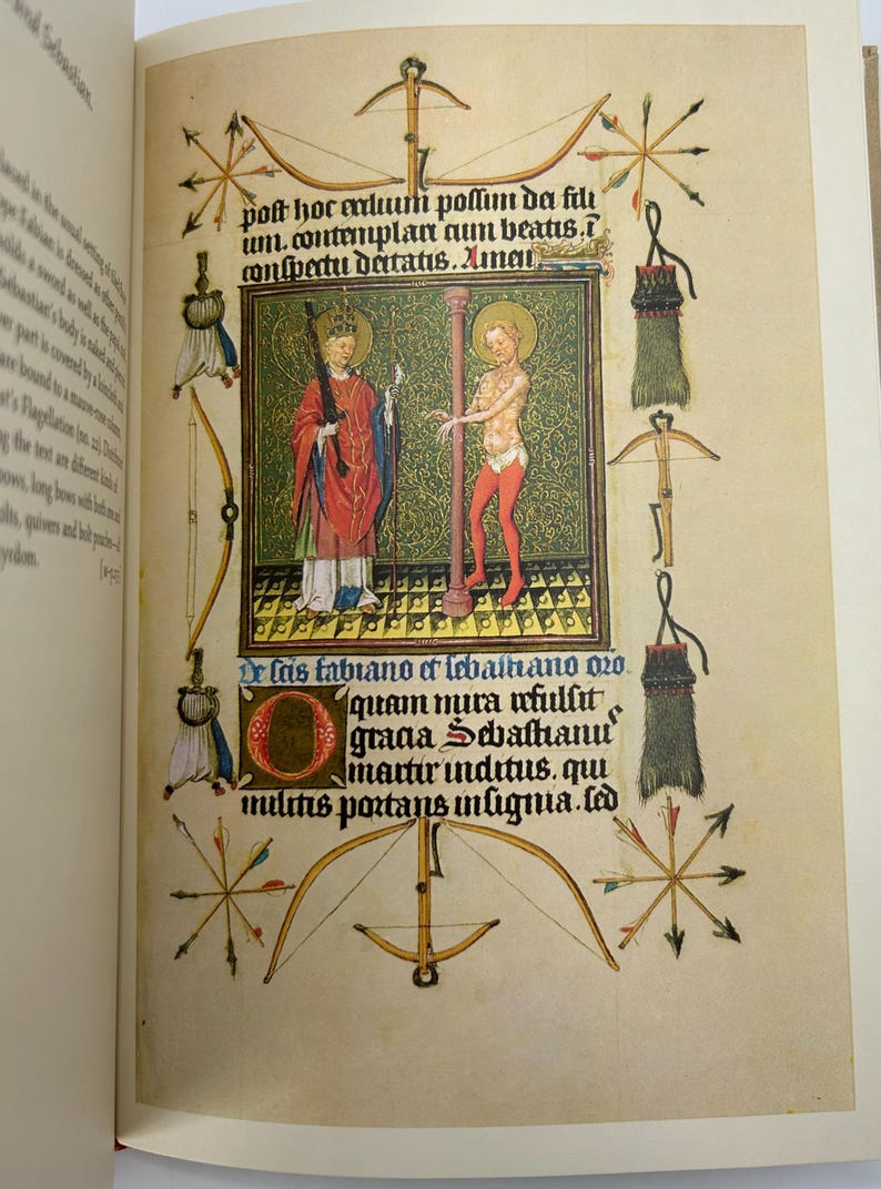 May include: An illuminated manuscript page featuring two figures within a green and gold frame. The page is adorned with bows, arrows, and text in Latin. The figures are dressed in red and white robes.