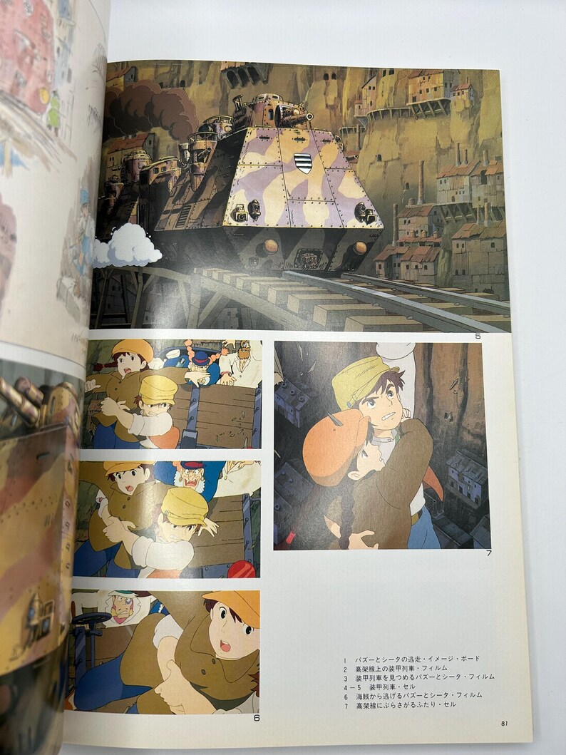 May include: An illustration from a Japanese animated film featuring a large, camouflaged train on tracks, set against a backdrop of a town built into a cliffside. Below, several panels depict characters in action, with text in Japanese.