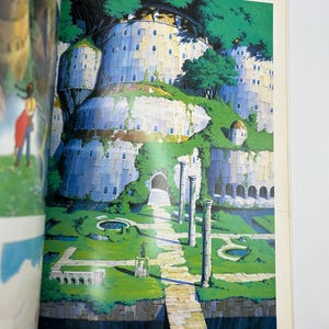 May include: An illustration of a fantasy landscape featuring a fortress-like structure with multiple levels and rounded towers. The structure is surrounded by lush greenery, including trees and grass. A stone pathway leads to the fortress, with classical columns and small ponds.