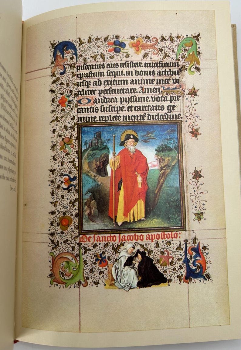 May include: An open book displaying a page from a medieval manuscript. The page features ornate floral borders, text, and a central illustration of a figure in red robes. The text includes the words "De Jando lambo apoltolo:"