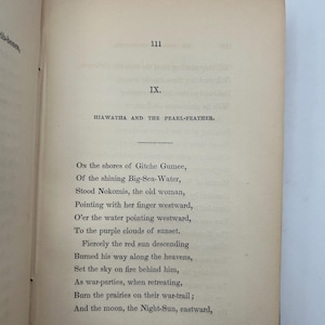 May include: Open book with text from the poem "Hiawatha and the Pearl-Feather". The page number 111 is visible. The text is in black ink on aged, off-white paper. The book is open to a poem.