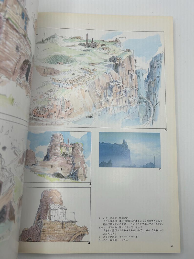May include: Watercolor illustrations of a fantasy landscape with buildings and cliffs. The image is from a book, with Japanese text and numbers visible. The artwork depicts a village and a bridge.